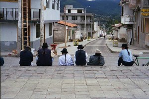 Local men sitting on a street in Ecuador.