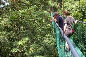Visitors looking over a bridge in Costa Rica.