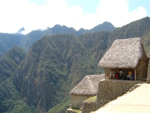 A group sitting in the shade at Peruvian ruins.